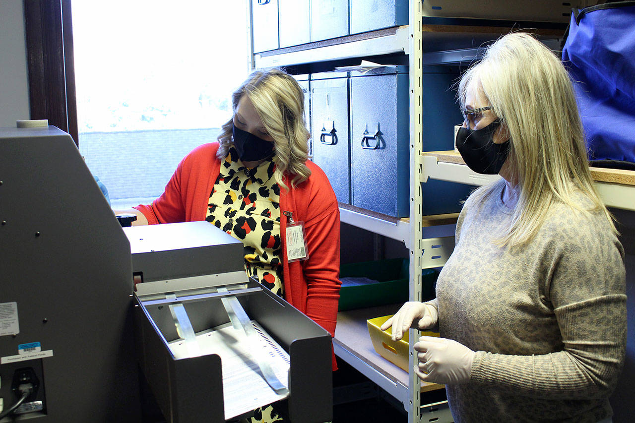 Jefferson County Election Coordinator Quinn Grewell, left, and Chief Deputy Auditor Brenda Huntingford tabulate special election ballots on Tuesday at the Jefferson County Courthouse. Election results can be viewed online at peninsuladailynews.com at about 9 p.m. after the polls close at 8 p.m. (Zach Jablonski/Peninsula Daily News)