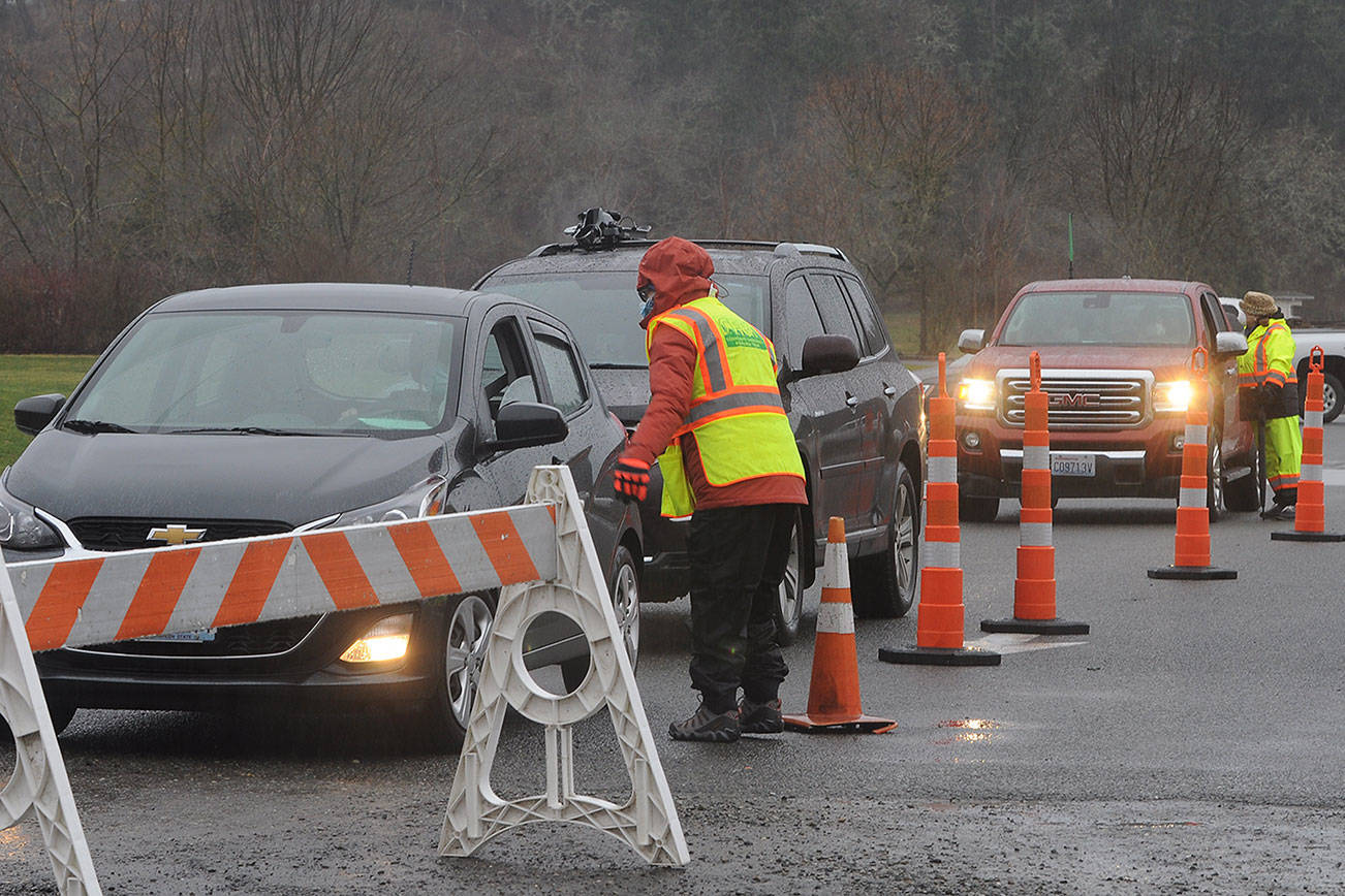 Members of the Community Emergency Response Team talk with patients at the Jamestown S’Klallam Tribe’s COVID-19 vaccination clinic on Feb. 4. The dose 2 clinic scheduled for Saturday has been cancelled because of expected inclement weather. Michael Dashiell/Olympic Peninsula News Group