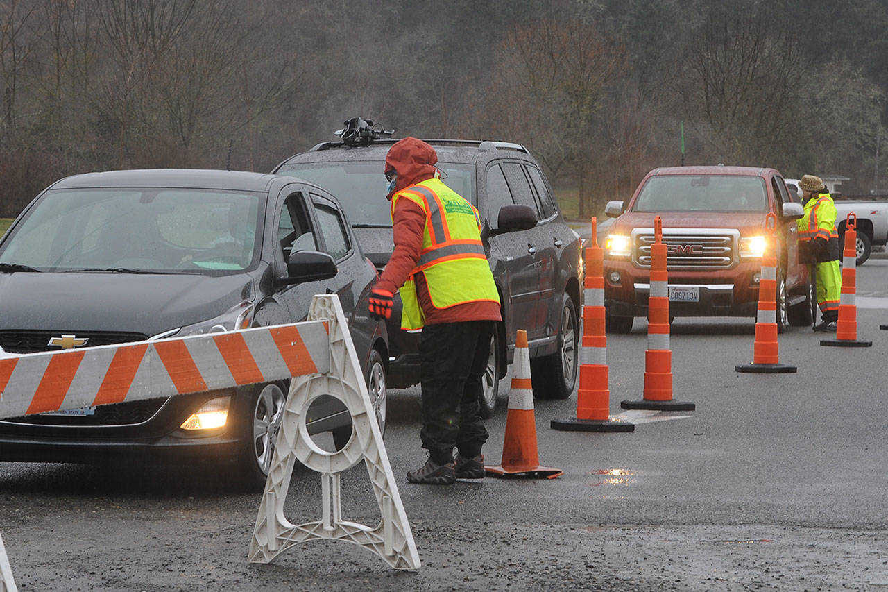 Members of the Community Emergency Response Team talk with patients at the Jamestown S’Klallam Tribe’s COVID-19 vaccination clinic on Feb. 4. The dose 2 clinic scheduled for Saturday has been cancelled because of expected inclement weather. Michael Dashiell/Olympic Peninsula News Group