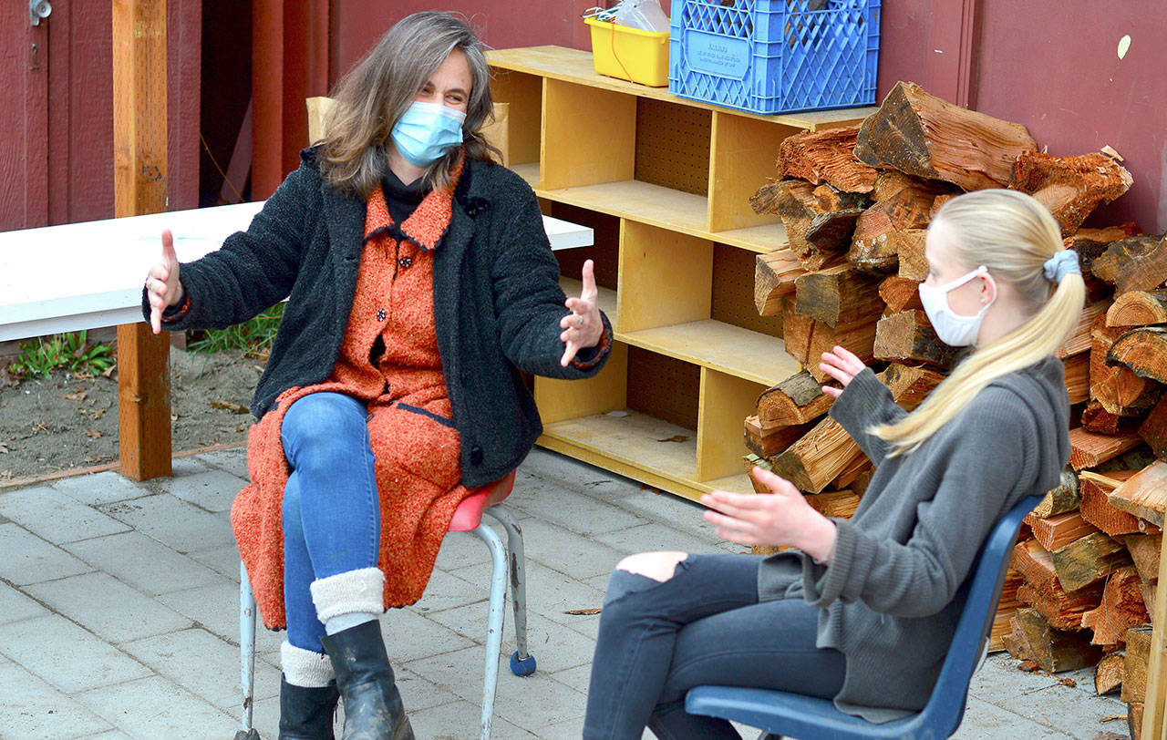 Benji Project teacher Heather McRae-Woolf talks with her daughter Orlanda on the Swan School patio, the setting for a new mindfulness circle for teens in Port Townsend. (Diane Urbani de la Paz/Peninsula Daily News)