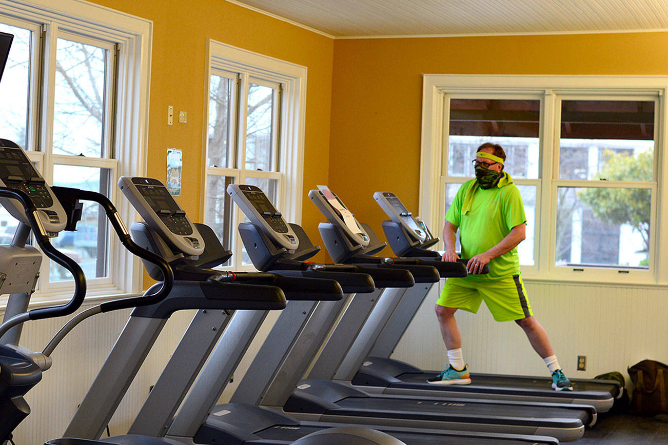 Richard Maxwell stretches before his Friday workout at the Port Townsend Athletic Club, which is about to double its capacity as North Olympic Peninsula gyms move into Phase 2 of the state's economic recovery plan. Diane Urbani de la Paz/Peninsula Daily News