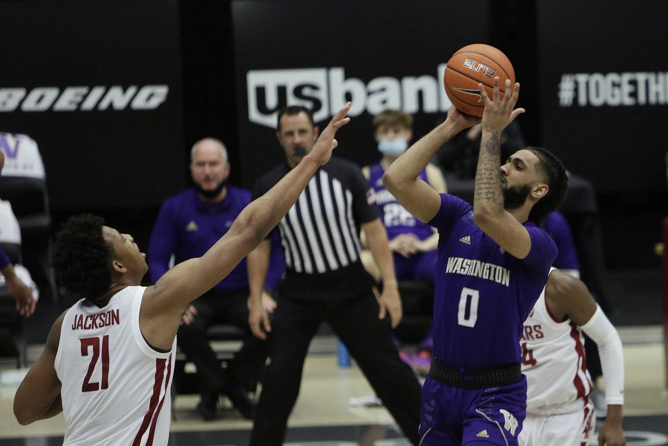 Washington guard Marcus Tsohonis (0) shoots over Washington State center Dishon Jackson (21) during the second half of an NCAA college basketball game in Pullman, Wash., Monday, Feb. 15, 2021. (AP Photo/Young Kwak)