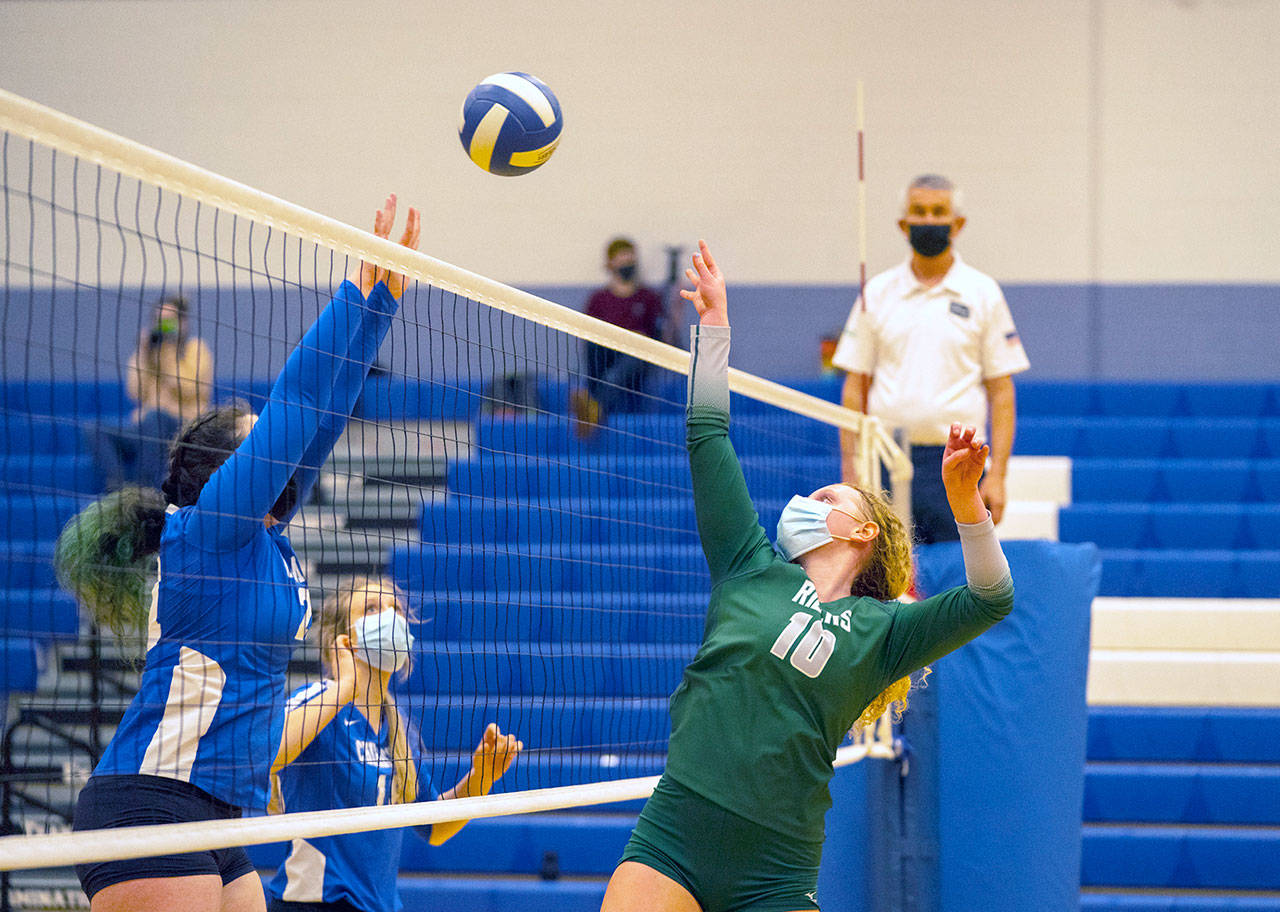 Port Angeles’ Kennedy Bruch, 10, defends the net against East Jefferson Volleyball Team of Katie Ballard, left, and Sophie Patterson during a Tuesday game in Chimacum. (Steve Mullensky/For Peninsula Daily News)