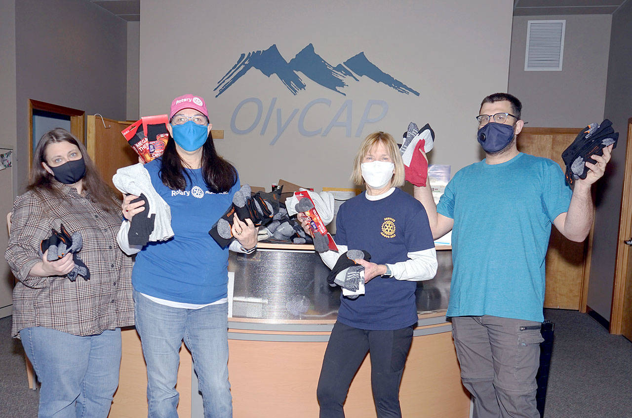The Port Towsend Sunrise Rotary Club announced that its recent sock drive collected more than 200 pairs of new, warm outdoor sock for distribution to people at need.
The socks have been donated the Olympic Community Action Program who will oversee their distribution.
Pictured, from left to right, Cherish Cronmiller, OlyCAP executive director; Jayne Neu, Port Townsend Sunrise Rotary member; Lois Sherwood, Port Townsend Sunrise Rotary Club president; and Sam McCulloch, OlyCAP shelter outreach