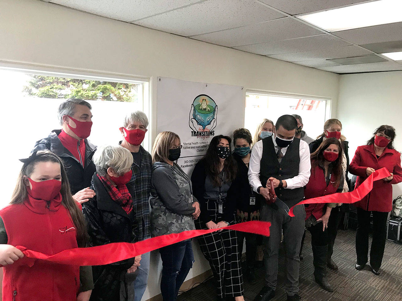 The Port Angeles Ambassadors helped with a ribbon-cutting ceremony for Healthy Transitions, 717 S. Peabody St., which will provide mental health outreach services for residents of Clallam County. From left are McKaylee Anderson, Christopher Thomsen, Edna Peterson, Steve Hargis, Kerrie Morrison, Aloma Sisco, Raelyn Bowechop, Jessica Wright, Jesse Charles, Brad Holloway, Leslie Robertson, Martha Cunningham and Julie Hatch.