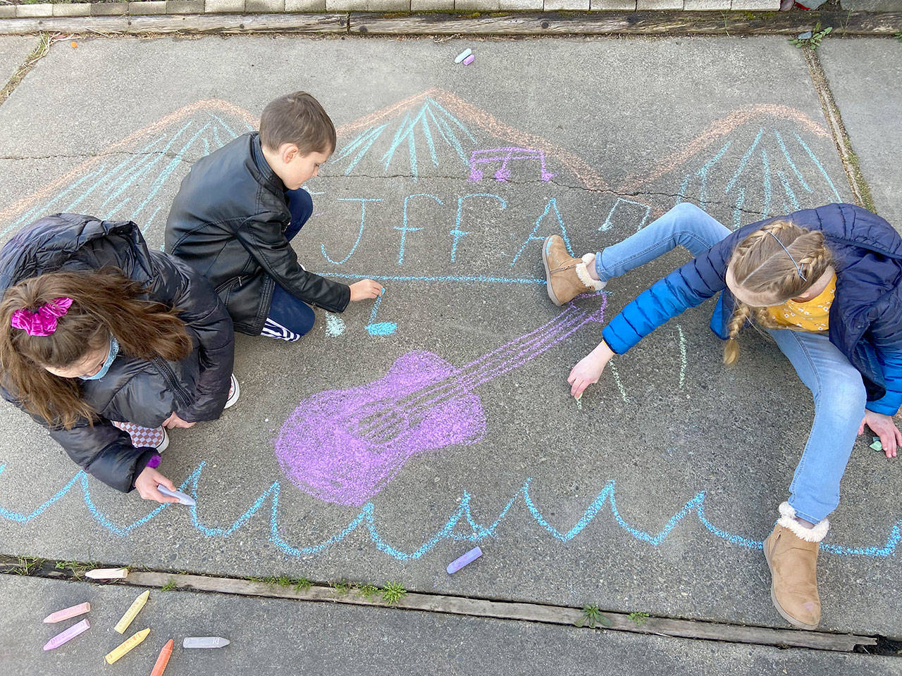 Warming up for Saturday’s “Chalk It Up!” event are Cate Chance, 11, left, Lucas Chance, 7, and Sarah Butterworth, 10, all of Port Angeles. (Photo courtesy Juan de Fuca Foundation for the Arts)