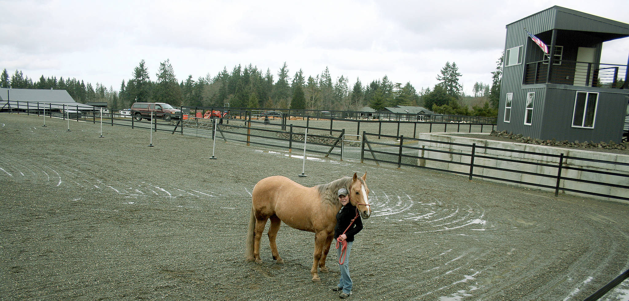 Kari Payne stands in front of her two story announcer’s stand for her 4L Arena on South McCrorie Road in Port Angeles. She wants to give back to the community by supporting local horse and rescue organizations and offering low or no cost use of her the arena for shows and events. (Karen Griffiths/for Peninsula Daily News)