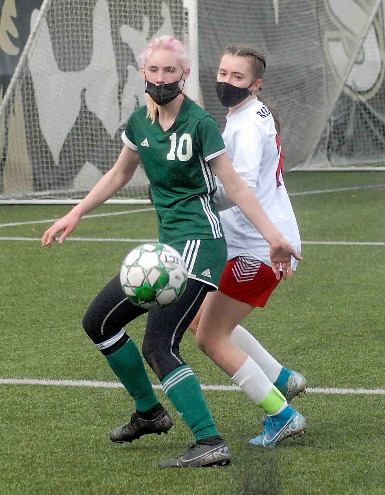 Keith Thorpe/Peninsula Daily News Port Angeles’ Millie Long, left, fends off the defense of East Jefferson’s Sorina Johnston during the first half of their Saturday match-up at Peninsula College in Port Angeles.