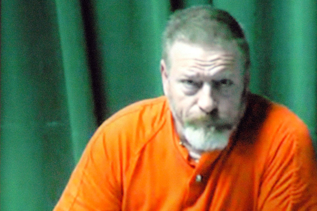 Keith Thorpe/Peninsula Daily News
Dennis Bauer makes is first video appearance in Clallam County Superior Court in Port Angeles on Friday after he was arrested Thursday in connection with a triple homicide in December. Inset in the two-way video appearance is Superior Court Judge Brian Coughenour.