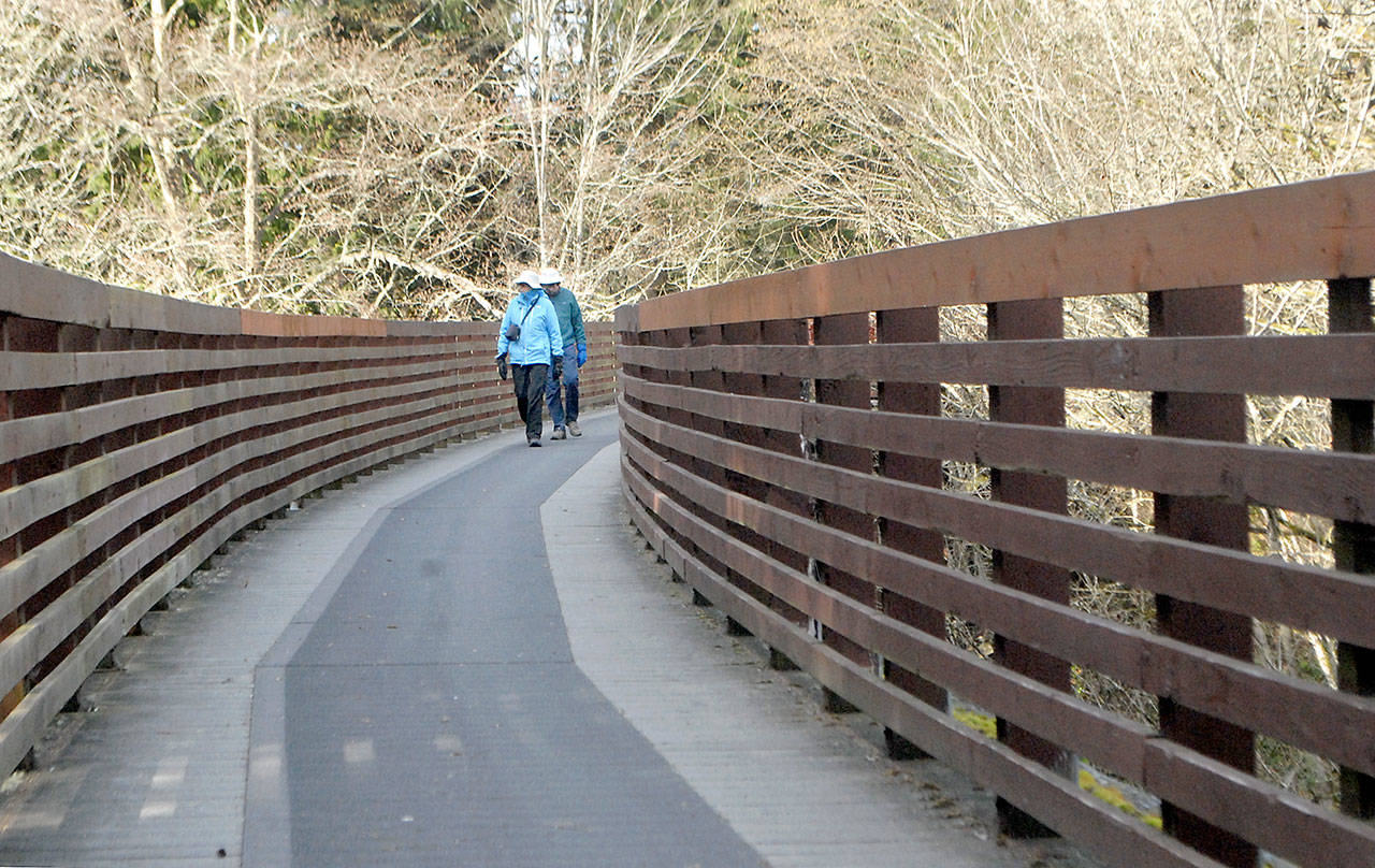 Joan and Bill Henry of Sequim stroll along the Johnson Creek Trestle, part of the Olympic Discovery Trail spanning Johnson Creek east of Sequim. The 410-foot-long trestle was refurbished in 2003 from a former railroad span and opened to pedestrian traffic. (Keith Thorpe/Peninsula Daily News)