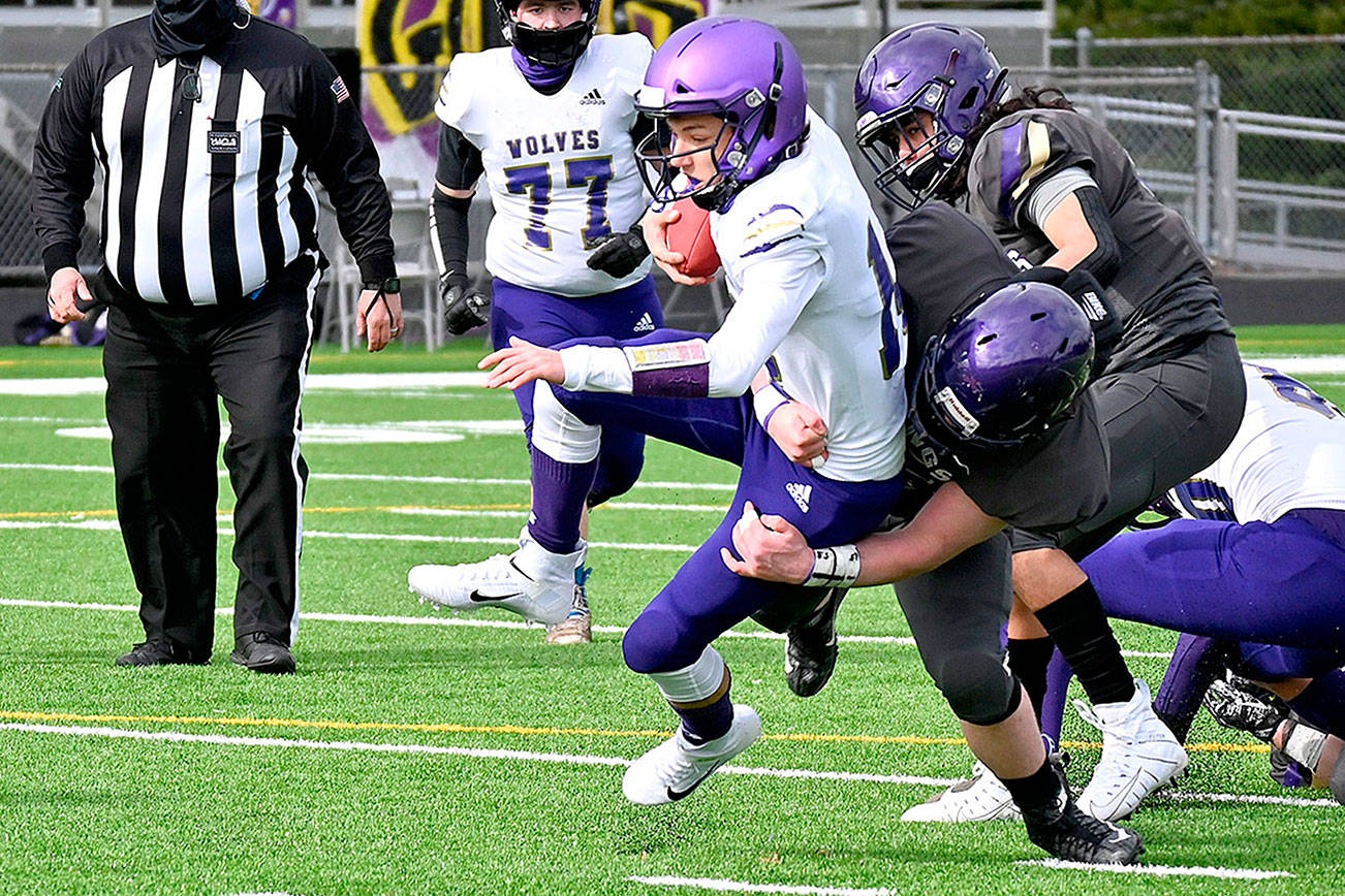 North Kitsap defenders tackle Sequim quarterback Kobe Applegate in the first half of the Vikings' 28-0 rout of their Olympic League rivals in Poulsbo on Saturday afternoon. Michael Dashiell/Olympic Peninsula News Group