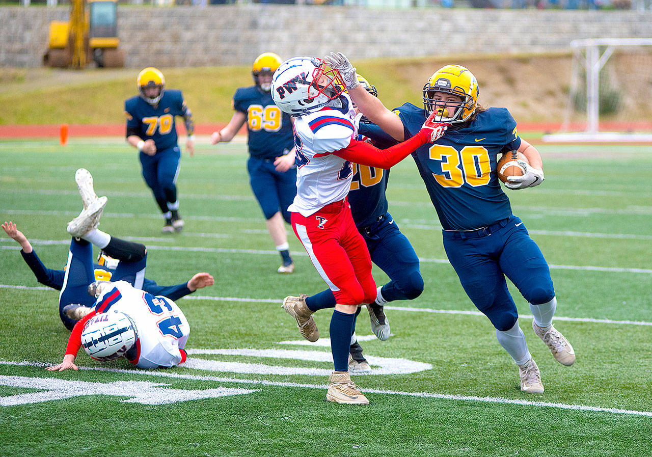 Forks’ Hayden Baker (30) runs the ball against Pe Ell-Willapa Valley on Saturday. (Eric Trent/Daily Chronicle)