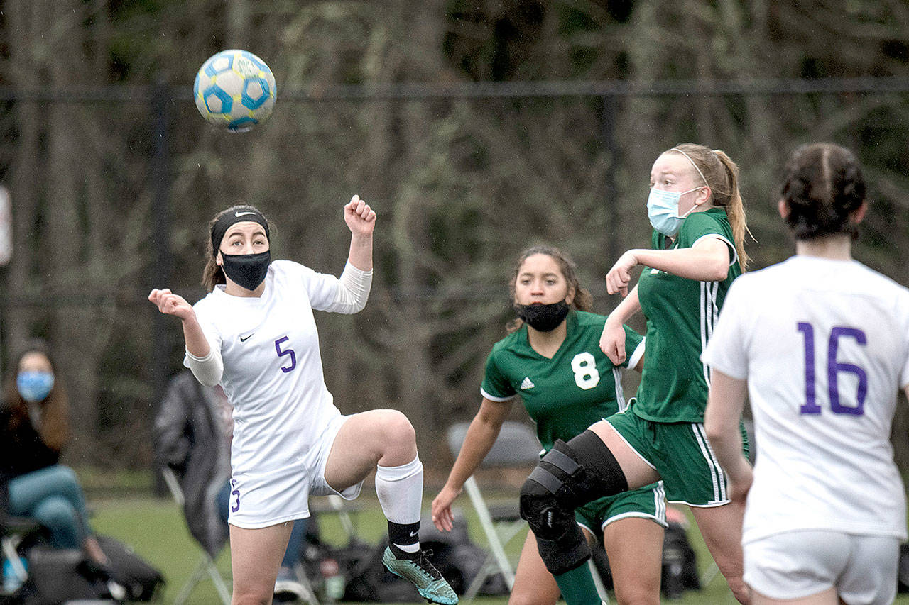 Sequim’s Kariya Johnson (5) and Port Angeles’ Anna Petty battle over a loose ball Saturday at Wally Sigmar Field at Peninsula College. (Jesse Major/for Peninsula Daily News)