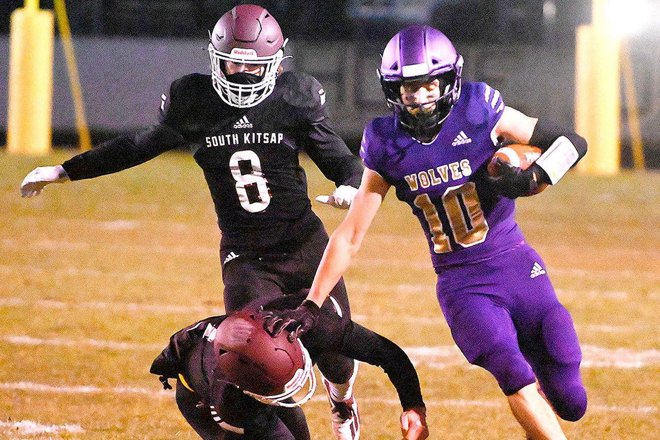 Sequim senior Garrett Hoesel, right, picks up 54 yards on a punt return in the first half of Sequim’s 27-15 home win over South Kitsap on Friday. Michael Dashiell/Olympic Peninsula News Group