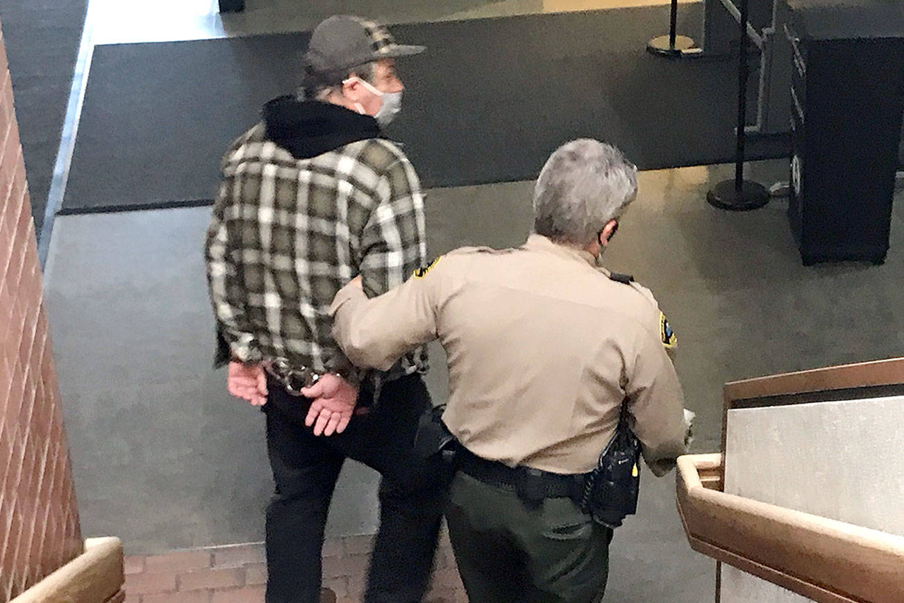 David Allen of Forks is led away to the Clallam County jail Wednesday to await sentencing after pleading guilty to two counts of child rape. (Paul Gottlieb/Peninsula Daily News)
