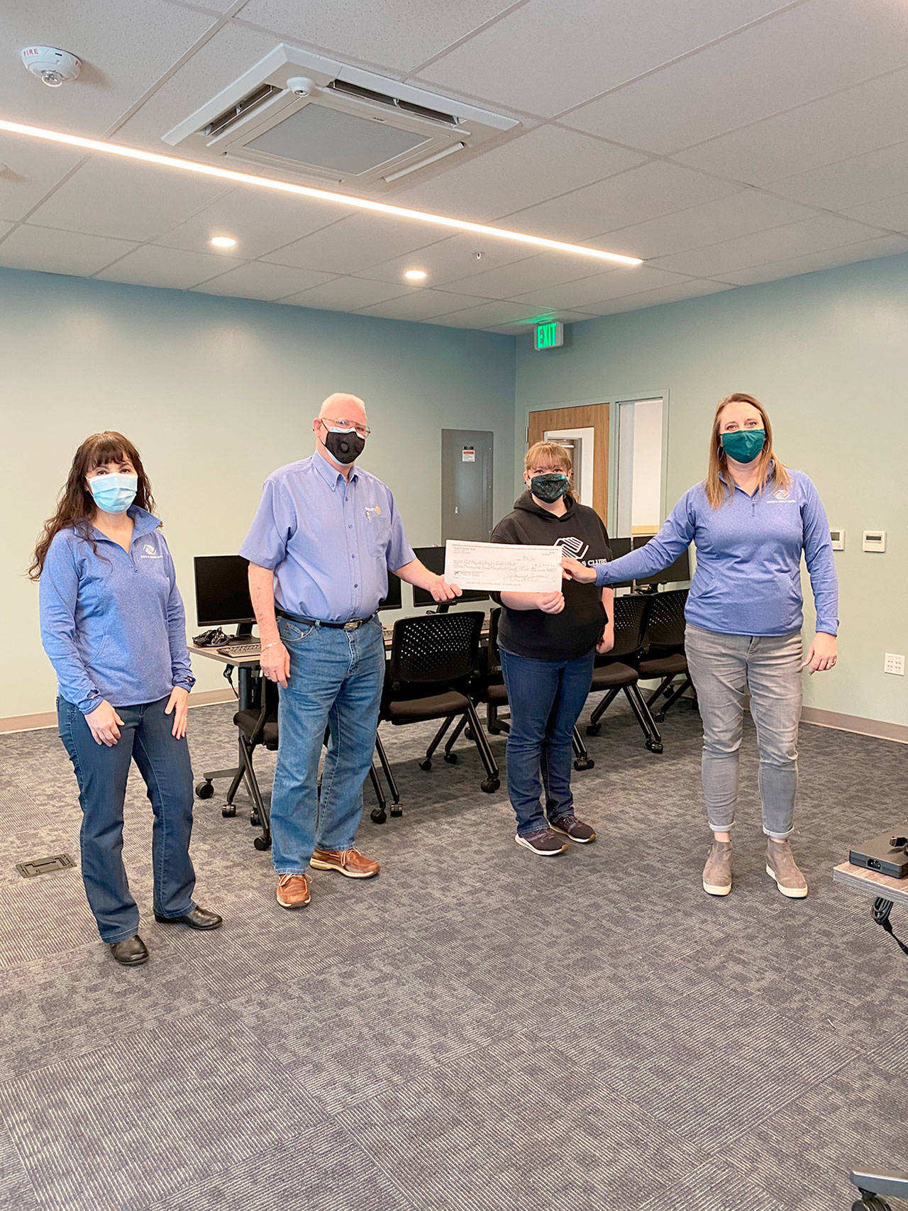 The Noon Rotary Club of Sequim recently donated funds to purchase 32 computer monitors for the Boys and Girls Clubs of the Olympic Peninsula. The monitors have been placed in the computer lab at the clubs’ Port Angeles unit. The rotarians also enjoyed a virtual tour of the new facility via Zoom. Pictured, from left to right inside the newly completed computer lab, are Mary Budke, Ted Shanks, Ashley Woolsey and Janet Gray.