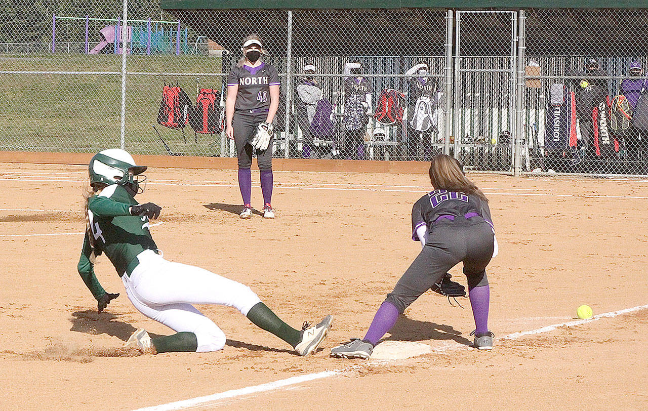 Port Angeles’ Teagan Clark slides safely into third base while North Kitsap’s Allison Dvorak fields the throw from the catcher during the Roughriders’ 5-4 walk-off win Monday at Dry Creek Elementary School. (Dave Logan/for Peninsula Daily News)