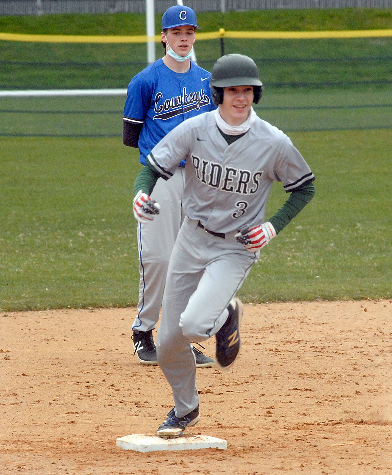 Port Angeles’ Landon Seibel rounds second past East Jefferson’s Ryan Popp after Seibel hamnered a bases loaded homer in the third inning on Tuesday at Port Angeles Civic Field.
Keith Thorpe/Peninsula Daily News