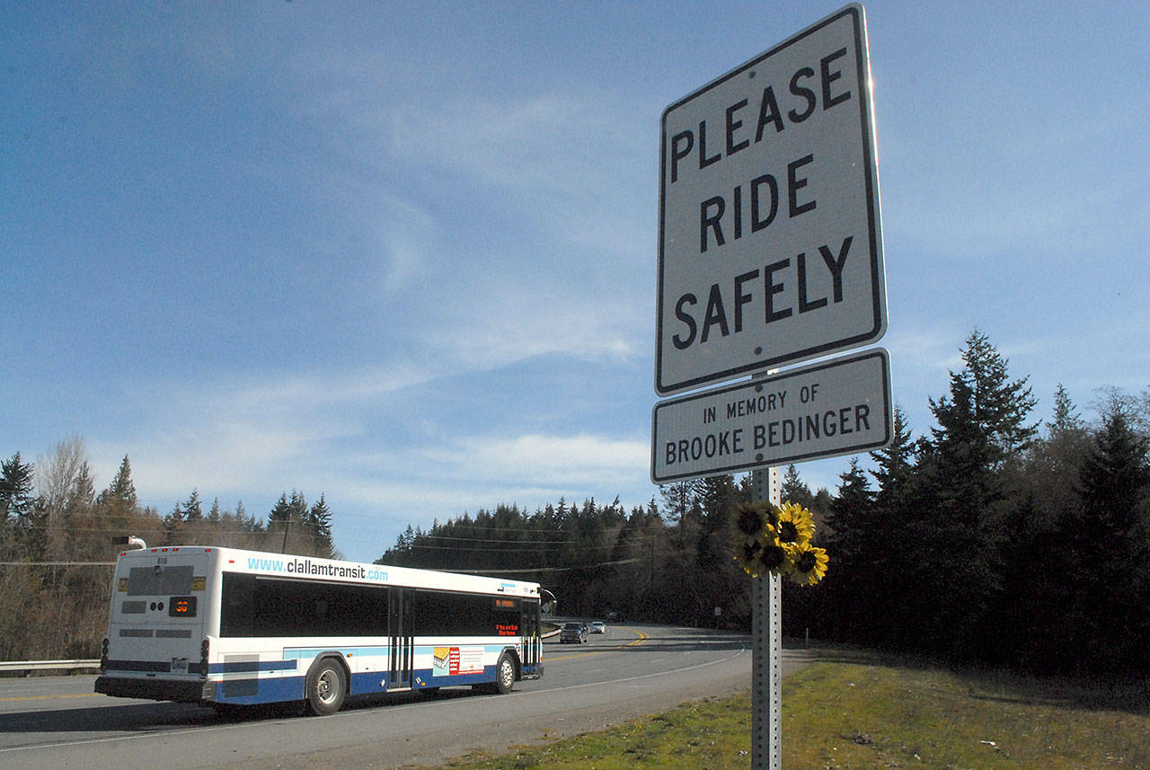 A sign honoring Brooke Bedinger, who was killed on her motorcycle near the spot, stands on the side of U.S. Highway 101 near Morse Creek east of Port Angeles. (Keith Thorpe/Peninsula Daily News)