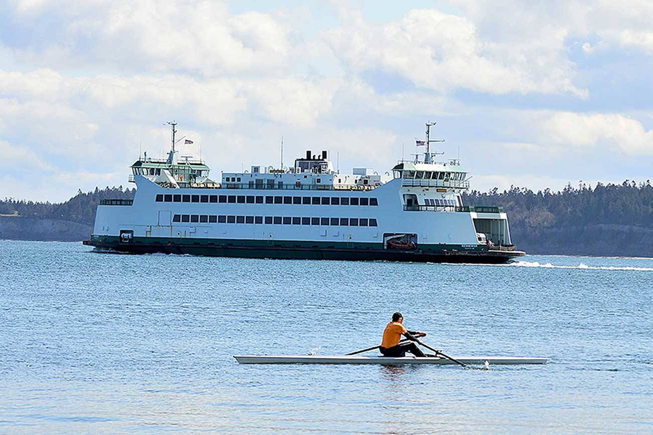 <strong>Diane Urbani de la Paz</strong>/Peninsula Daily News
Paul Carter of Port Townsend makes the most of the day’s sunshine as he joins a Washington State Ferry on Port Townsend Bay. Monday was his first time out on his single MAAS 24 rowing shell.