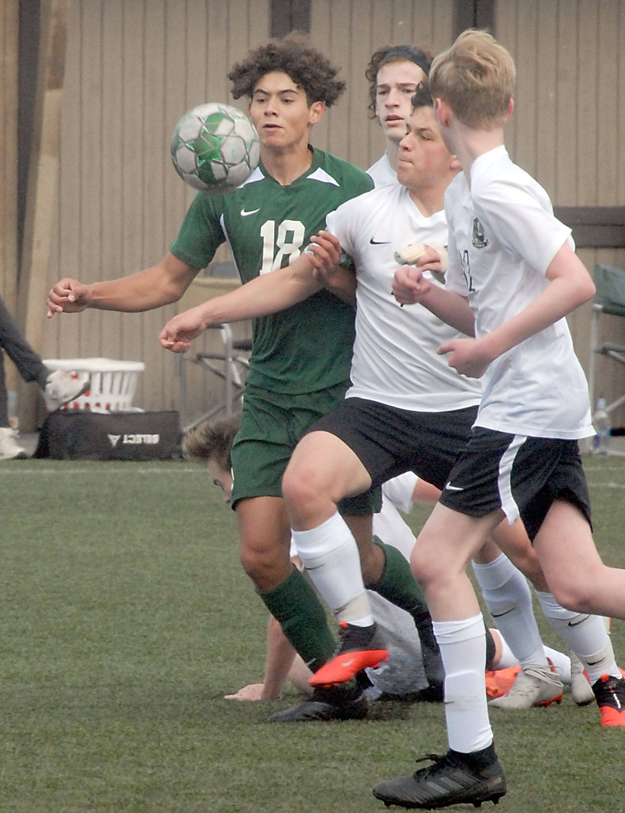 Keith Thorpe/Peninsula Daily News Port Angeles’ Dayton Williams, left, chases a loose ball against Klahowya players, from left, Zachary Sullivan, Oscar Peterson and Colin Swenland on Saturday at Wally Sigmar Field in Port Angeles.