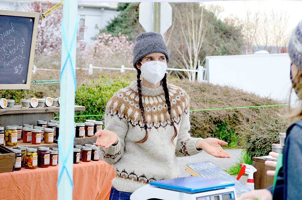 Meghan Mix of Hopscotch Farm is among dozens of vendors at the Port Townsend Farmers Market’s opening day Saturday. She had a busy day at her stand, selling salad greens, pickles and her popular beet relish. The market is on from 9 a.m. to 2 p.m. Saturdays at Tyler and Lawrence streets in Uptown Port Townsend. (Diane Urbani de la Paz/Peninsula Daily News)