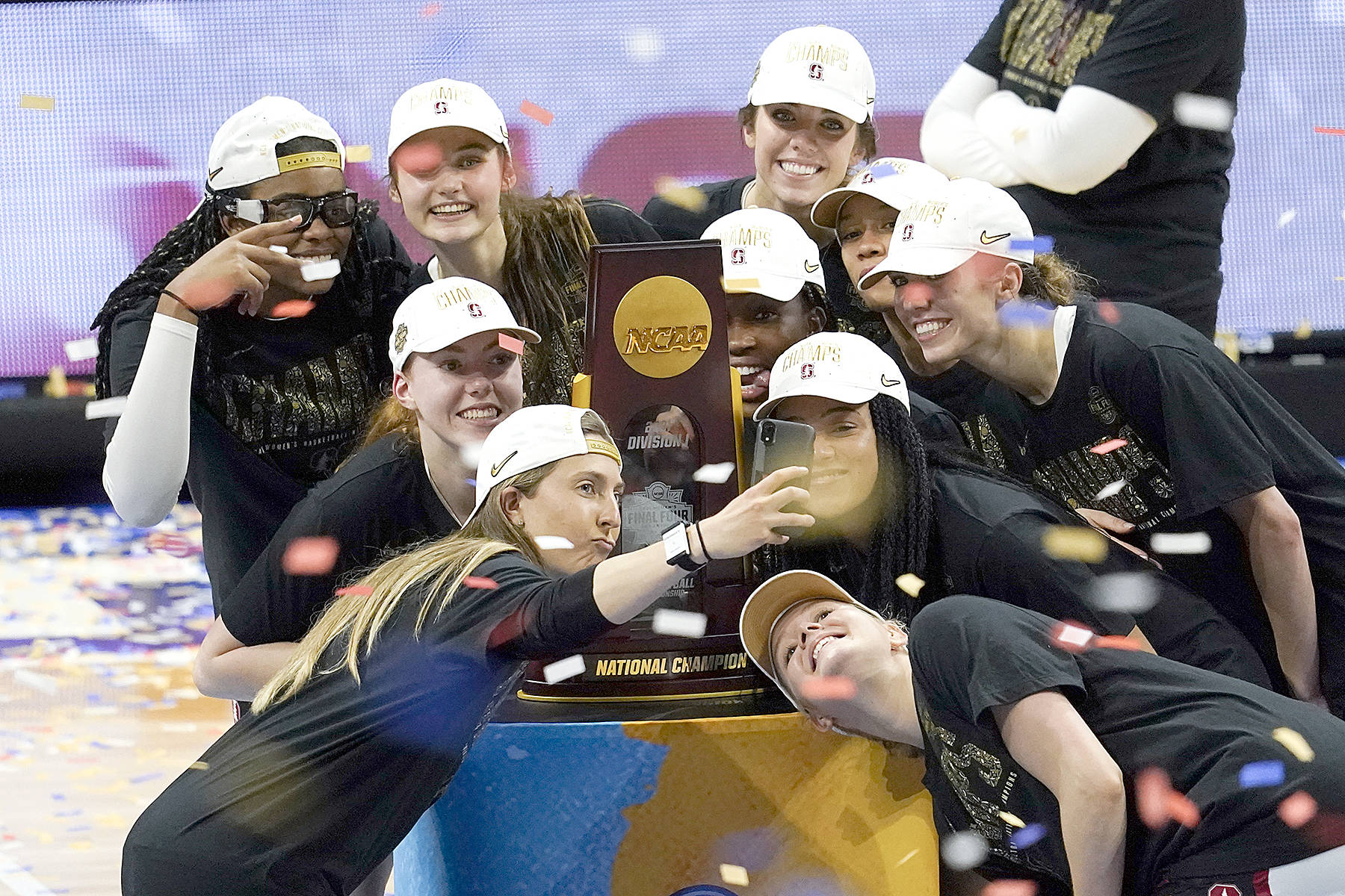 Stanford players celebrate with the trophy after the championship game against Arizona in the women’s Final Four NCAA college basketball tournament, Sunday, April 4, 2021, at the Alamodome in San Antonio. Stanford won 54-53. (AP Photo/Eric Gay)