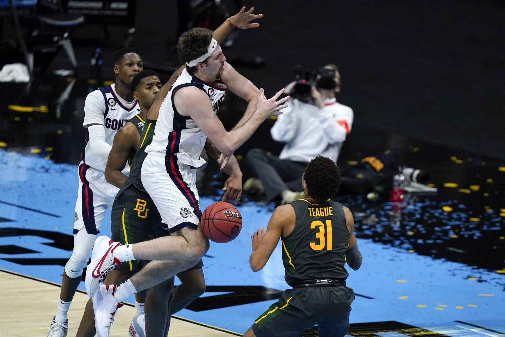 Gonzaga forward Drew Timme loses control of the ball in front of Baylor guard MaCio Teague (31) during the first half of the championship game in the men's Final Four NCAA college basketball tournament, Monday, April 5, 2021, at Lucas Oil Stadium in Indianapolis. (AP Photo/Michael Conroy)