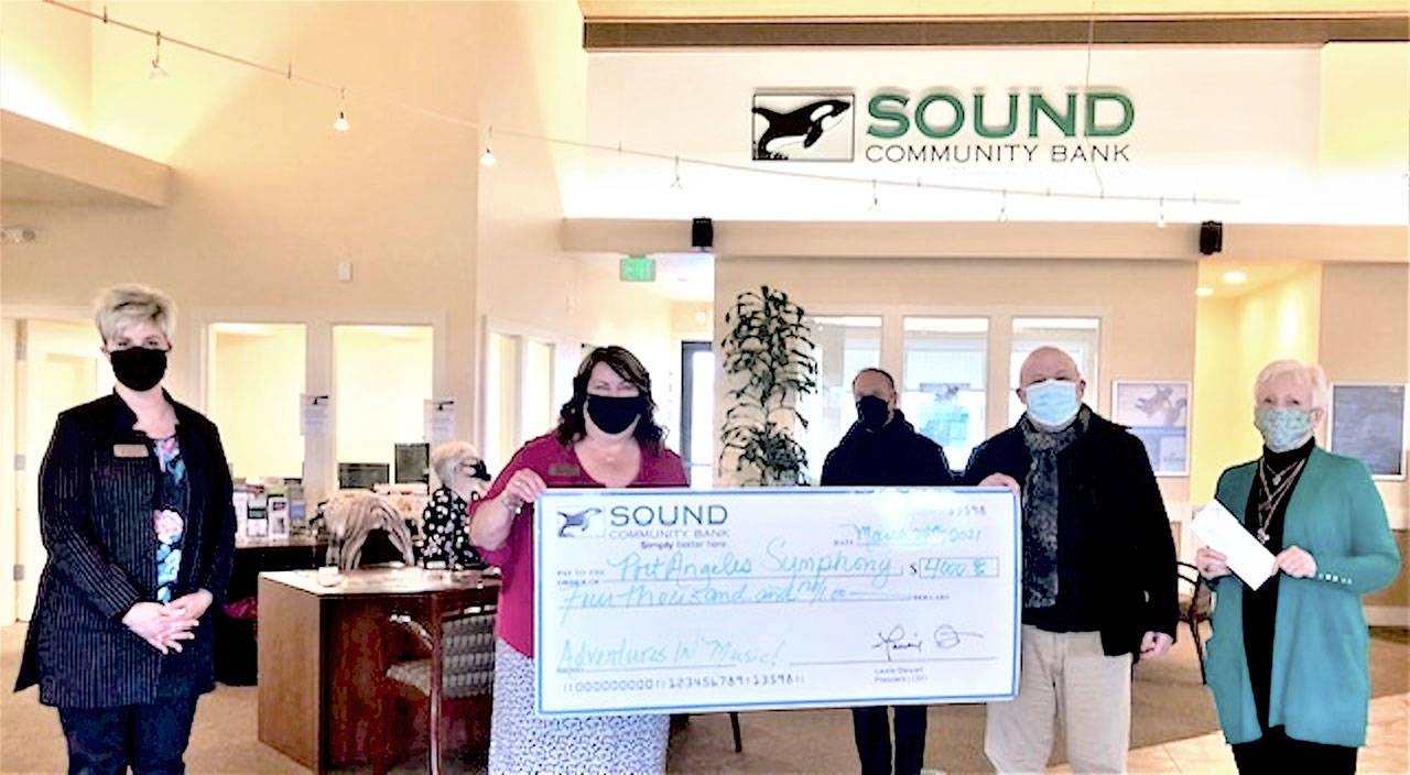 Accepting a donation from Sound Community Bank are Port Angeles Symphony conductor Jonathan Pasternack, center, Adventures in Music producer Al Harris and symphony board member Kathleen Balducci, at right; Sound Community Bank’s Laurie Szczepczynski is at left with Sequim manager Shelli Robb-Kahler. (Photo courtesy Sound Community Bank)