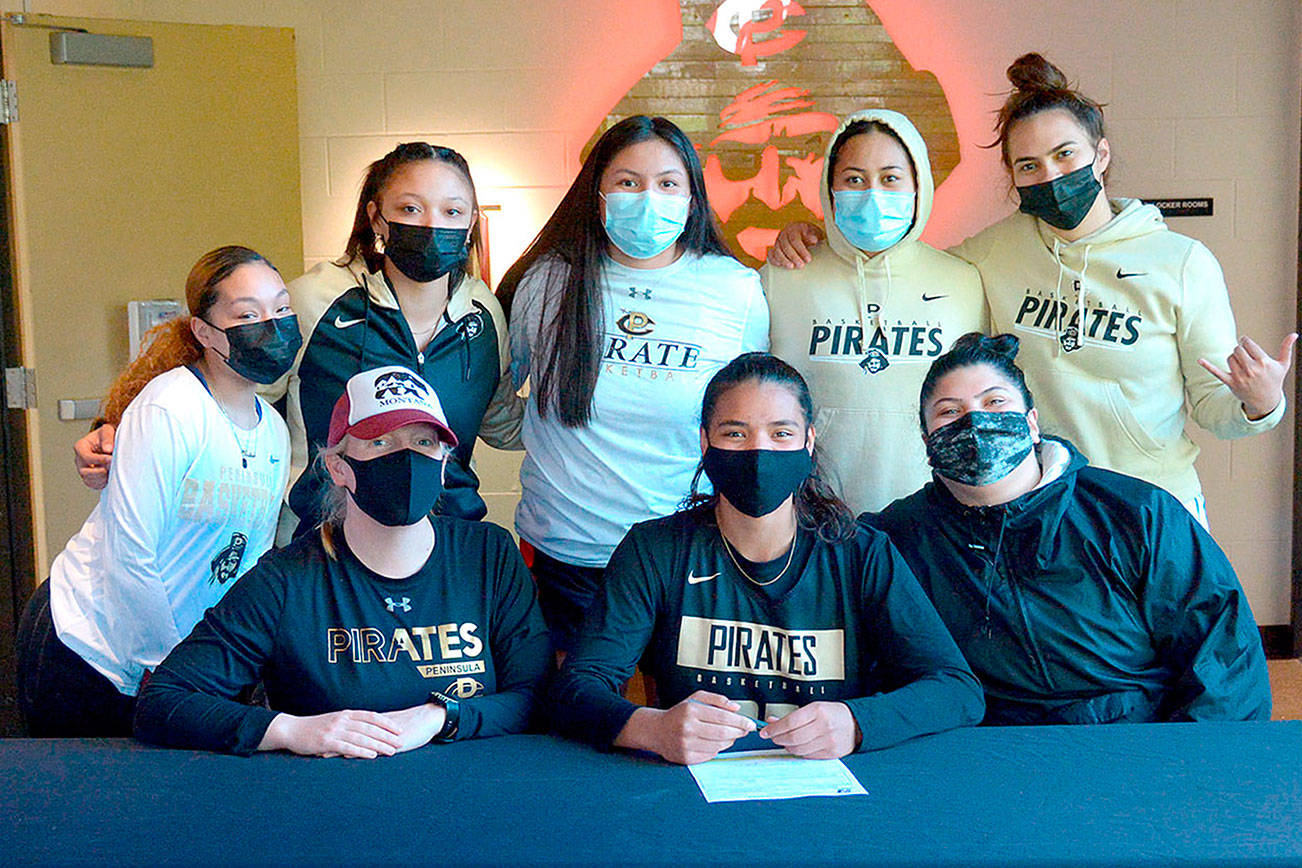 Photo courtesy of Peninsula College
Gina Brown, center, signs to play with the Peninsula College women's basketball court. At left is Peninsula women's coach Alison Crumb.