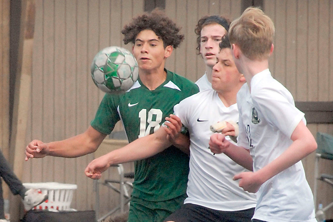 Keith Thorpe/Peninsula Daily News
Port Angeles' Dayton Williams, left, chases a loose ball against Klahowya players, from left, Zachary Sullivan, Oscar Peterson and Colin Swenland on Saturday at Wally Sigmar Field in Port Angeles.
