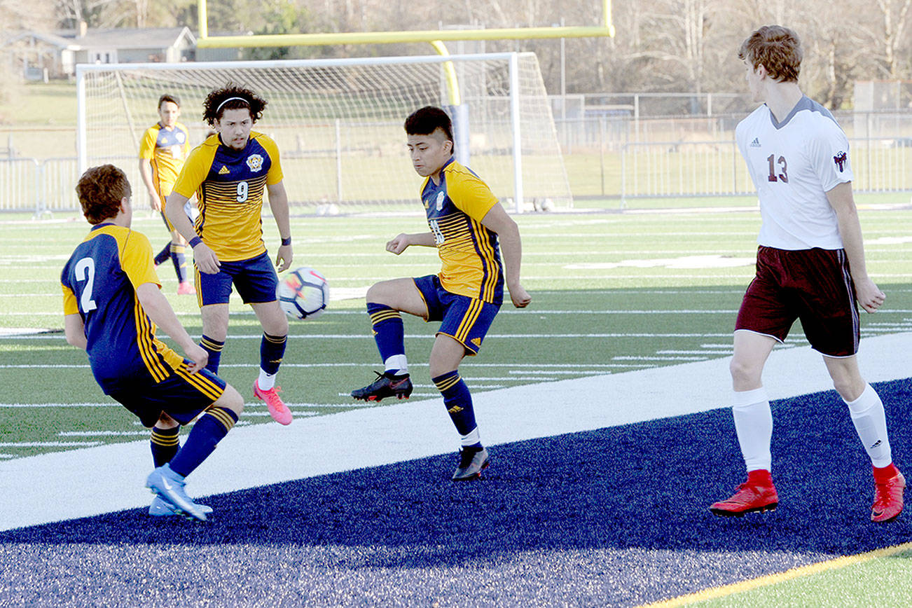 Spartans from left Juan Pablo Flores, Tony Flores-Hernandez and Andres Santos combine forces against Montesano on Tuesday at Spartan Stadium in Forks. (Lonnie Archibald/for Peninsula Daily News)