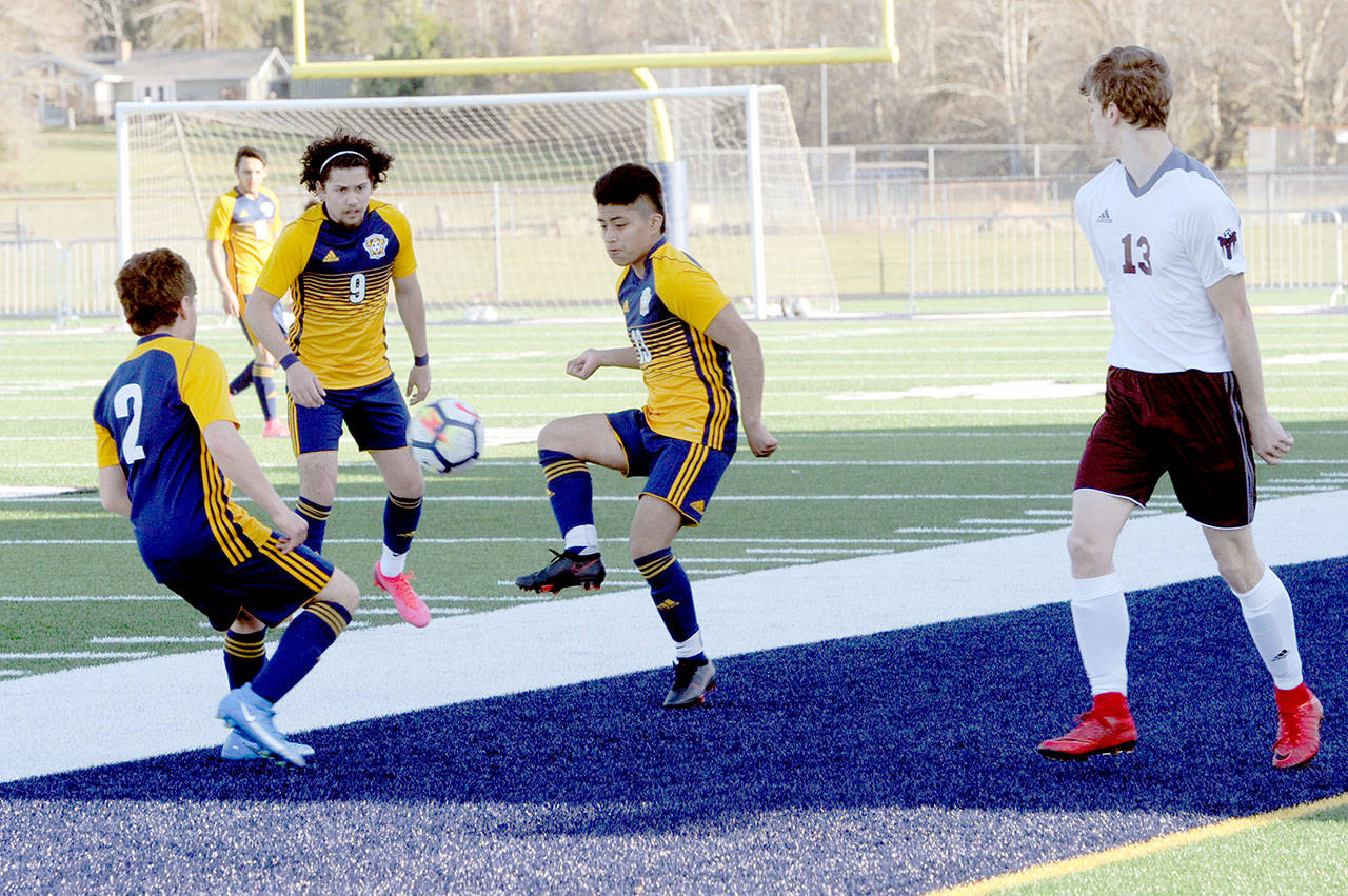 Spartans from left Juan Pablo Flores, Tony Flores-Hernandez and Andres Santos combine forces against Montesano on Tuesday at Spartan Stadium in Forks. (Lonnie Archibald/for Peninsula Daily News)