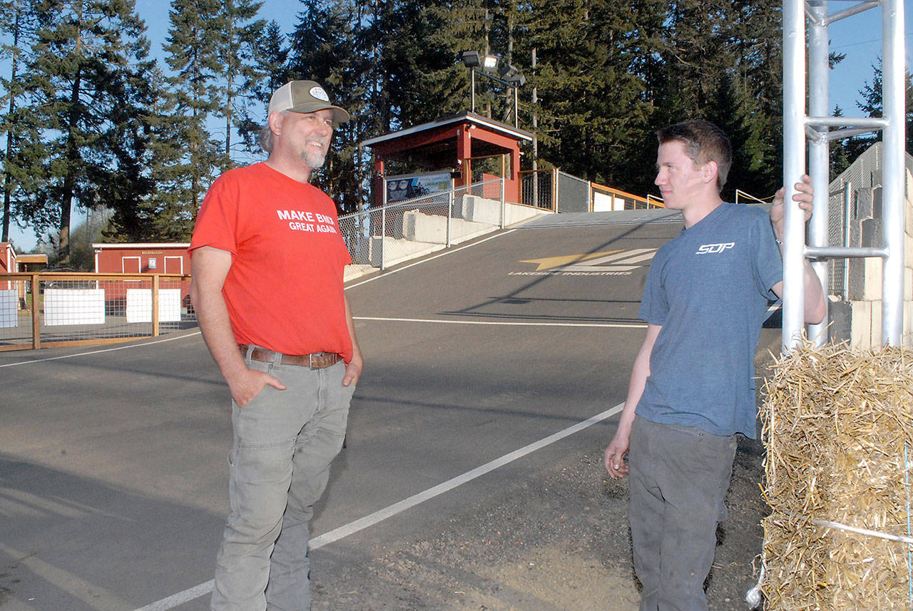 Port Angeles BMX track president and operator Sean Coleman, left, talks with track design assistant Colby Groves, 17, at the track. (Keith Thorpe/Peninsula Daily News)