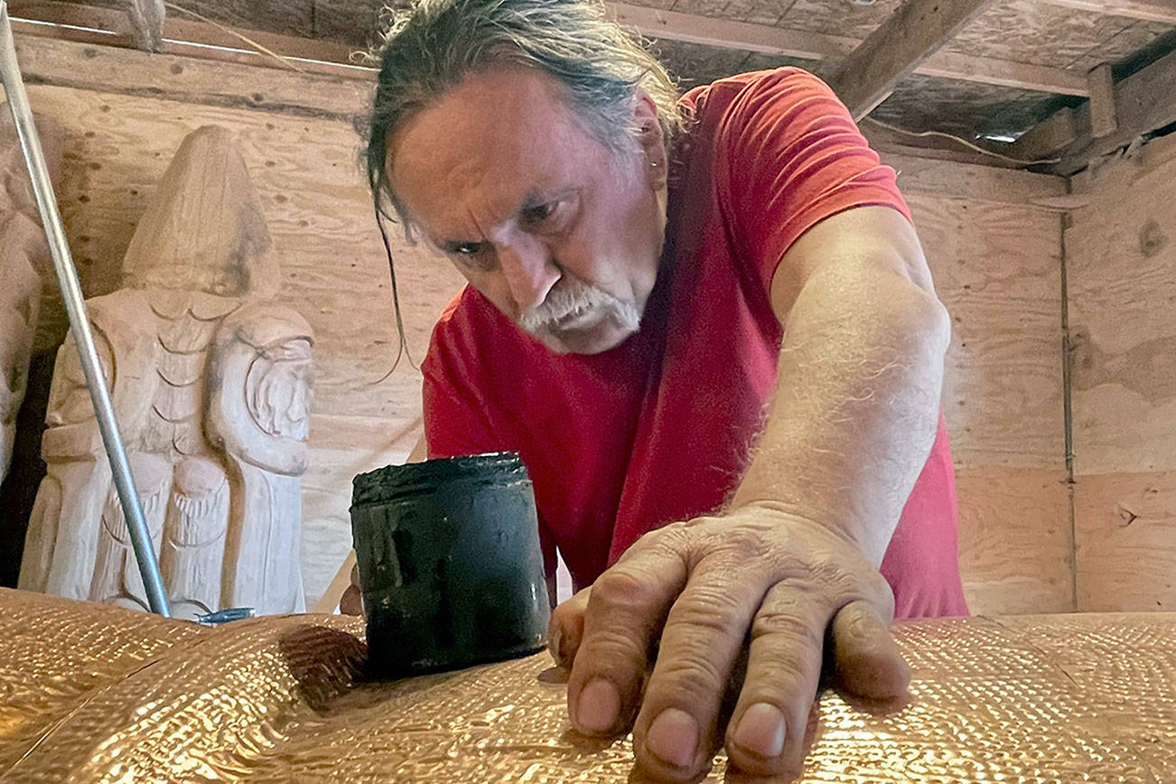 Carver Jewell James led the shaping of the nearly 25-foot totem pole that will be transported across the country this summer. The pole and its carvers will stop in Port Townsend on Saturday. (Photo courtesy of Freddie Lane Productions)