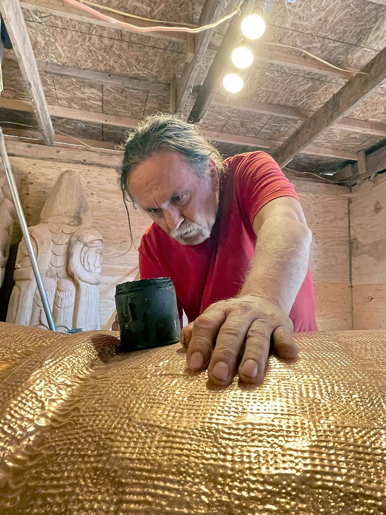 Carver Jewell James led the shaping of the nearly 25-foot totem pole that will be transported across the country this summer. The pole and its carvers will stop in Port Townsend on Saturday. (Photo courtesy of Freddie Lane Productions)