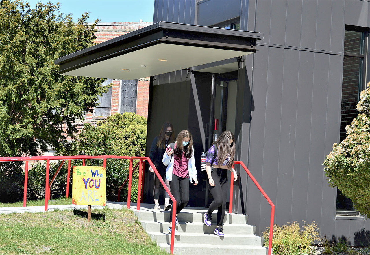 A variety of inspirational messages — the “Signs of Hope” — dot the Port Townsend High School campus, where, from left, Sage Wyatte, Jasmine Hansen and Gabby Newton head for class. (Diane Urbani de la Paz/Peninsula Daily News)