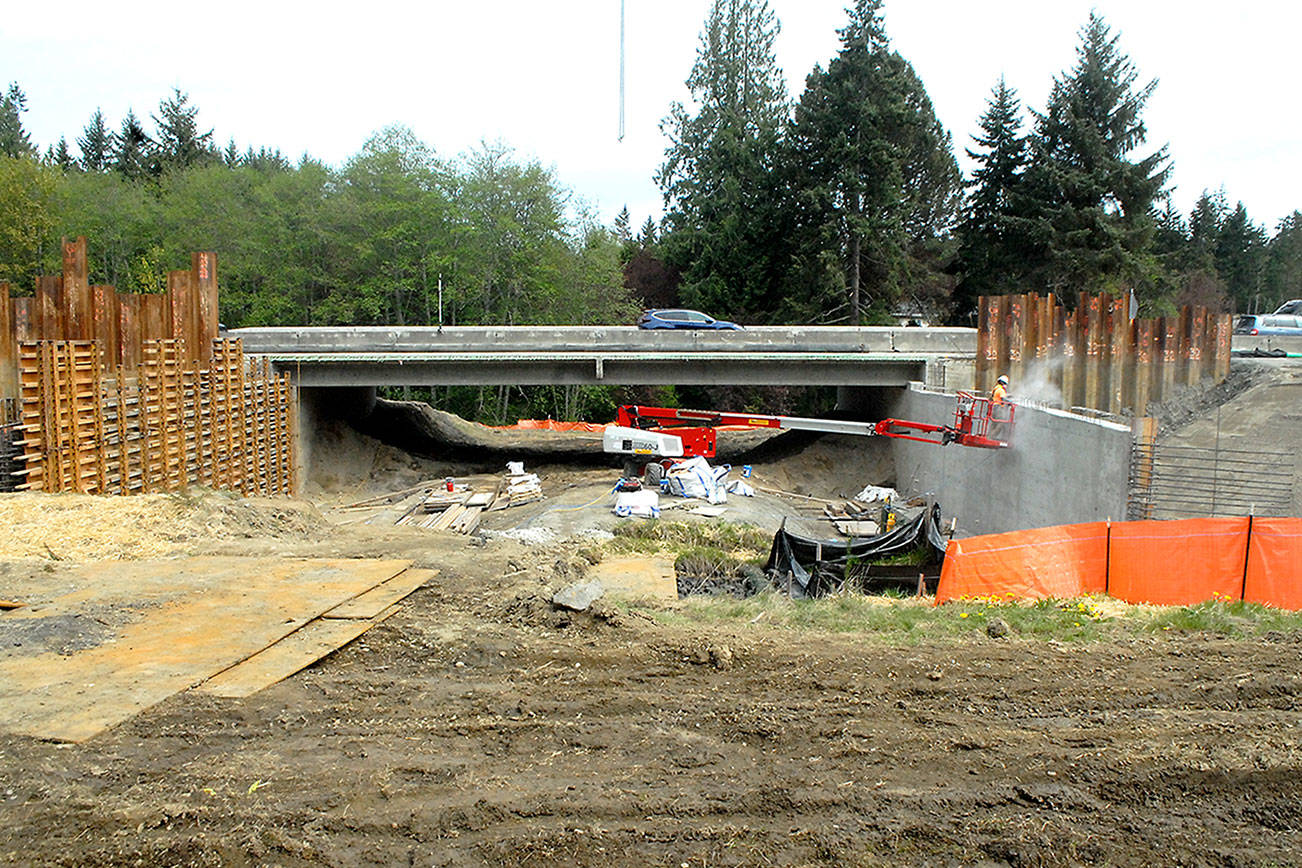 Traffic crosses a new bridge on U.S. Highway 101 over Bagley Creek east of Port Angeles on Wednesday as work continues on building a second bridge for the eastbound lanes. The project, designed to replace aging culverts for improved salmon habitat, also includes a new bridge over Siebert Creek farther east, as well as smaller box culverts on South Bagley Creek Road and James Page Road. The $30.6 million project, which is expected to last until late fall, currently has traffic constricted to a single lane in each direction through the two major construction zones. (Keith Thorpe/Peninsula Daily News)
