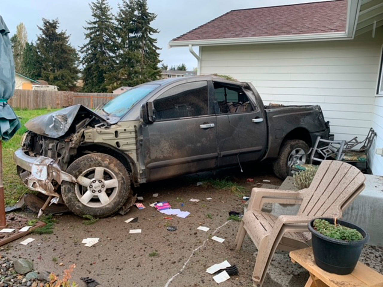 A pickup struck a house after hitting a tree off Woodcock Road in Sequim. (Photo courtesy of Clallam County Sheriff’s Office)