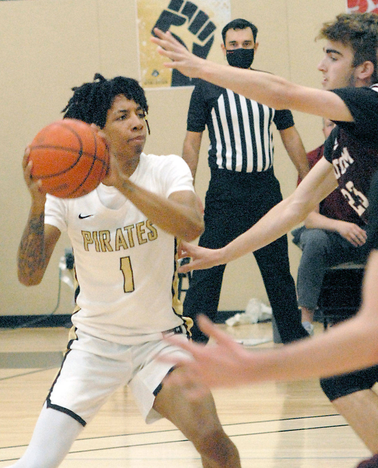 Peninsula’s Mikey Madlock, left, looks for a way to the hoop around Whatcom’s Jackson Short, right, during Friday’s game at Peninsula College in Port Angeles. (Keith Thorpe/Peninsula Daily News)