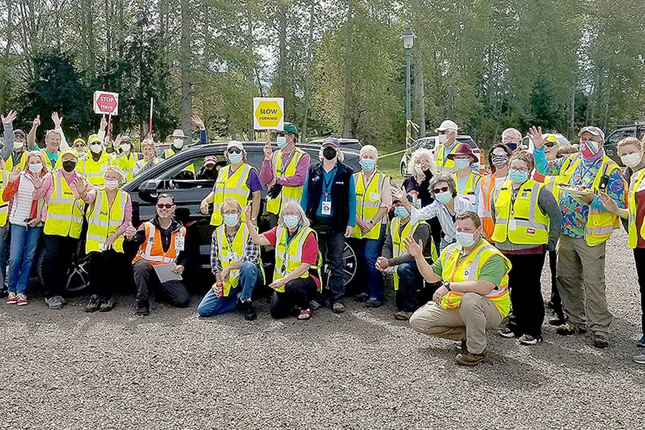 Jamestown Family Clinic workers and Community Emergency Response Team volunteers celebrate the final day of the mass vaccination drive-thru clinic Thursday at Carrie Blake Community Park in Sequim.