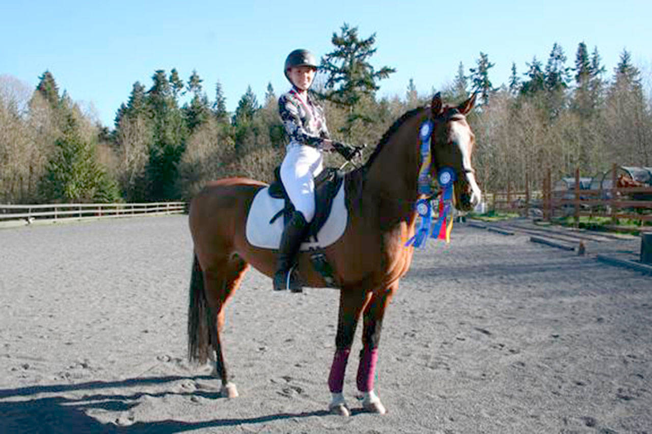 Jefferson County high school senior Emily Kilgore, on Antonio, is the first in the area to qualify to compete at the Interscholastic Equestrian Association’s National Dressage Finals this coming weekend in Texas. To up the competitive skill needed, riders compete on unfamiliar horses whose names they’ve drawn from a hat. (Karen Griffiths/for Peninsula Daily News)