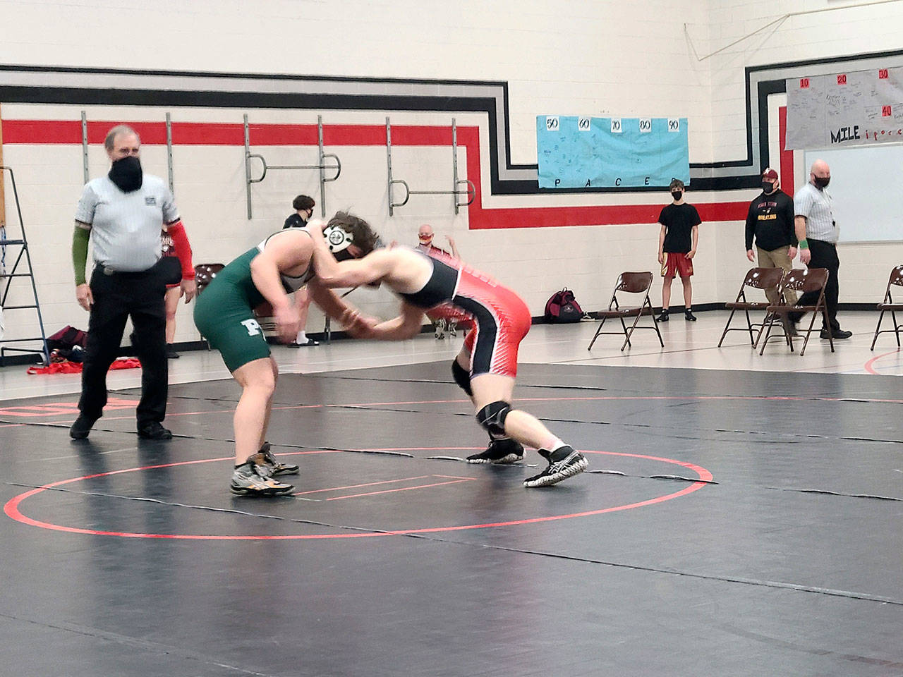 Port Angeles Wrestling Port Angeles’ Daniel Cable, left, and East Jefferson’s Kyle Caldwell square off in a 195-pound match during a dual-meet at Kingston High School. Caldwell, who placed second at state in 2020, won the match, but the Roughriders won both duals. (Port Angeles High School wrestling)