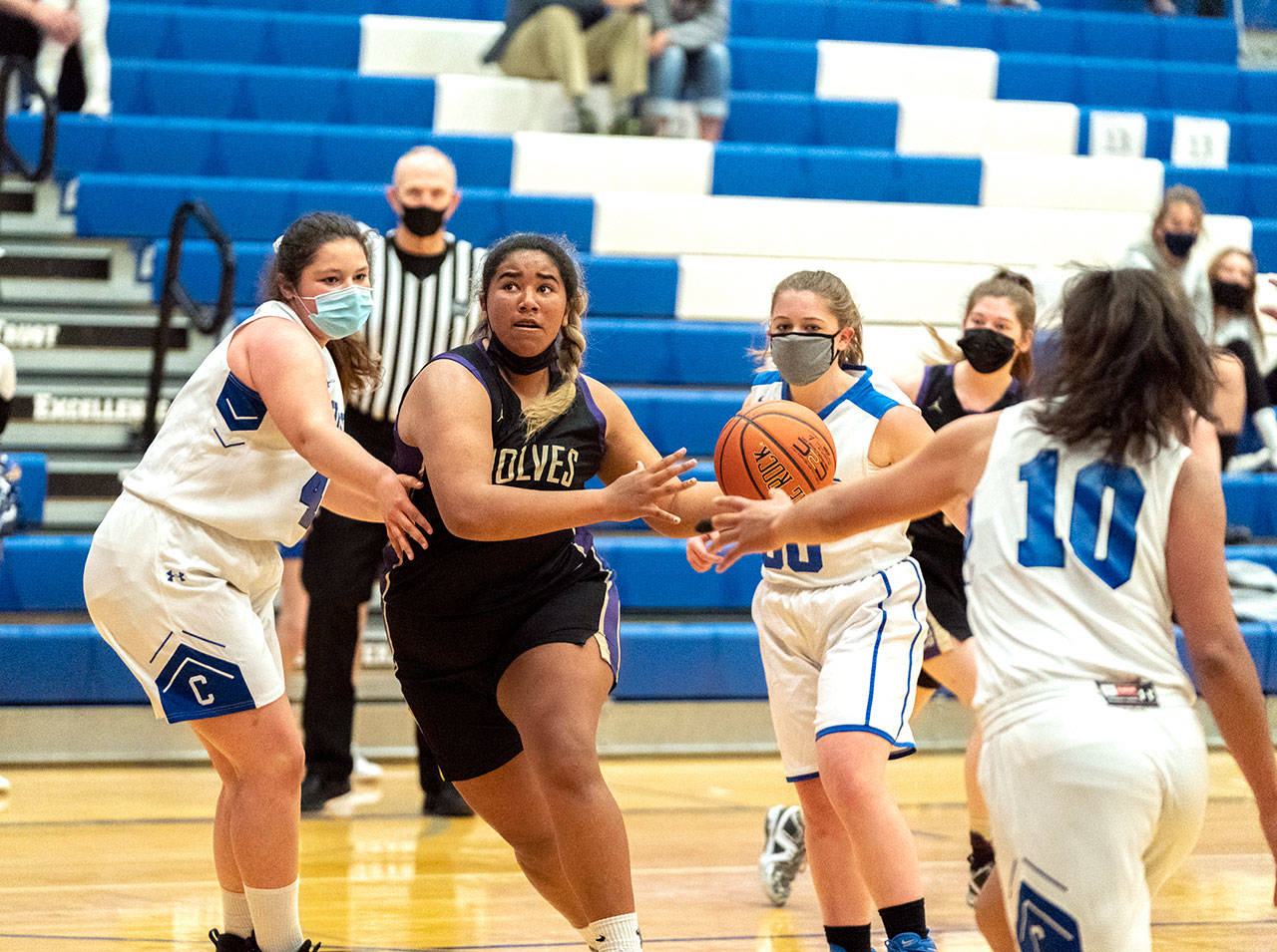 Sequim’s Jelissa Julmist keeps her eyes on the basket as she drives for a score against East Jefferson’s Alyssa Vandenberg, left, Shelby Theibelt (30) and Gina Brown during a Saturday game played in Chimacum. (Steve Mullensky/for Peninsula Daily News)
