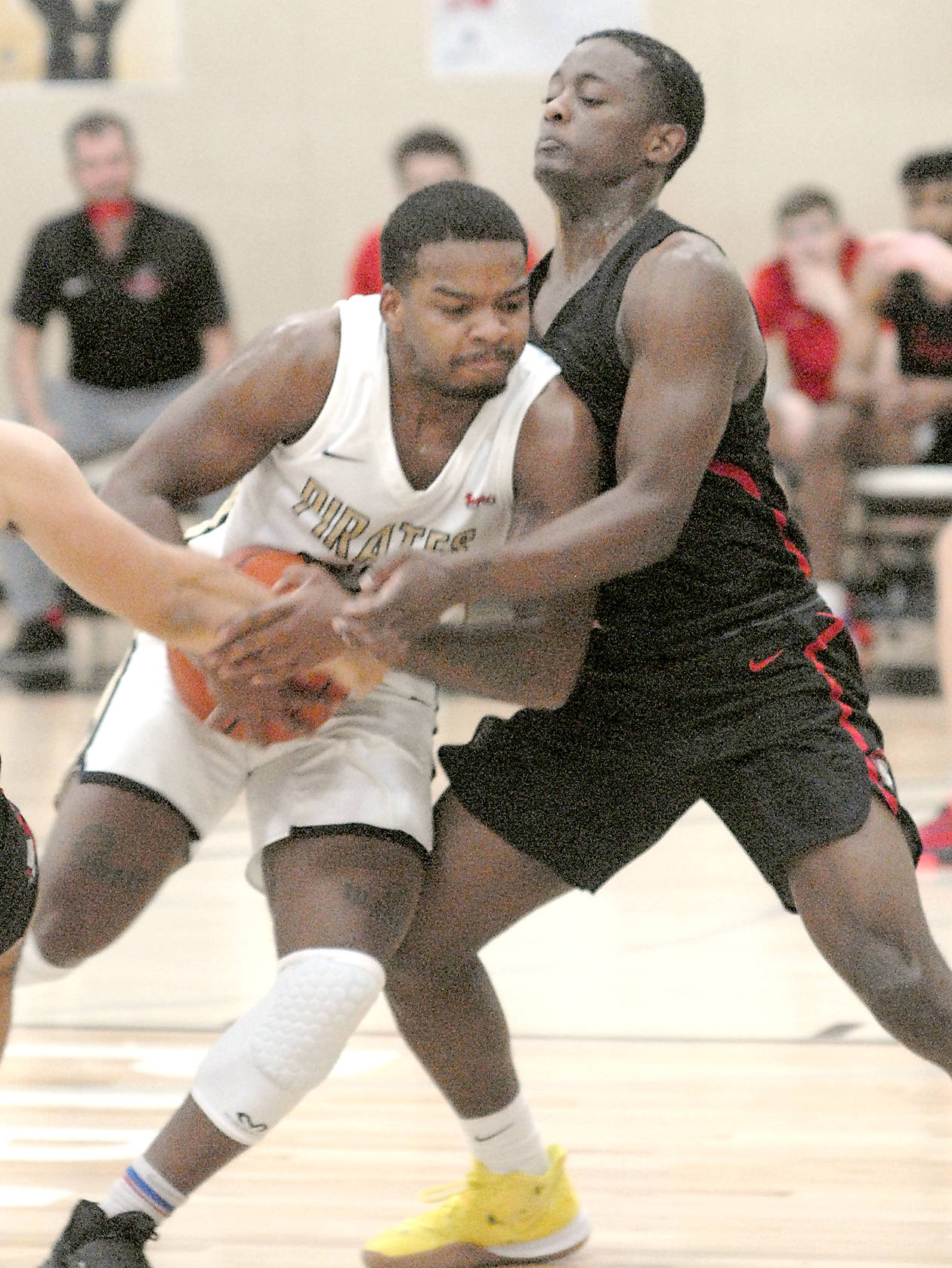 Keith Thorpe/Peninsula Daily News Peninsula’s Keith Seldon shoulders past Everett’s Brycen Dillworth during the first half of Saturday’s game in Port Angeles.