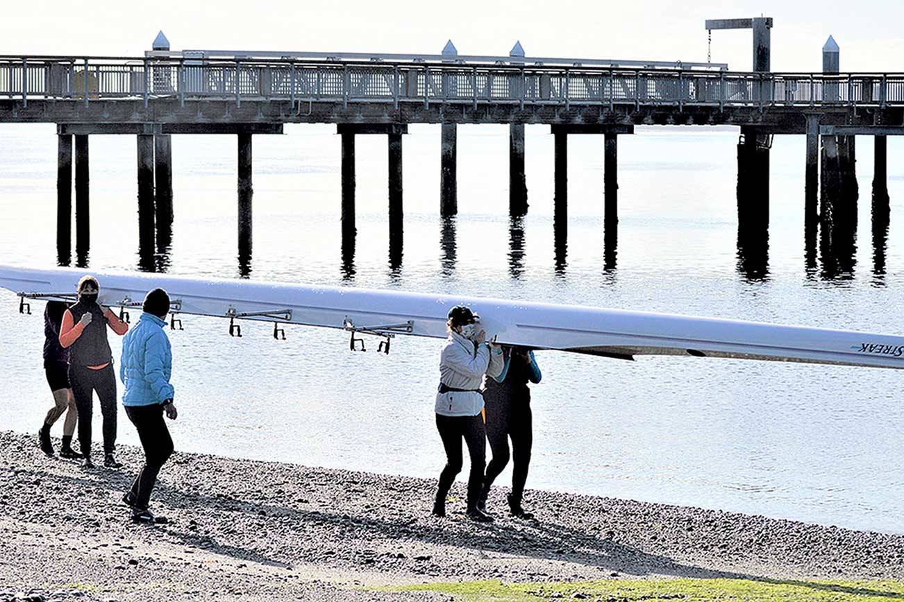 For the first time in a year, the Tuff as Nails rowing team took the Blue Streak for a sun-splashed spin in Port Townsend Bay on Monday morning. Coming back in are Nikki Russell, facing front at left, Barb Hager and Christine Edwards; on the other side of the boat are Mari Friend and Zoe Ann Dudley. (Diane Urbani de la Paz/Peninsula Daily News)