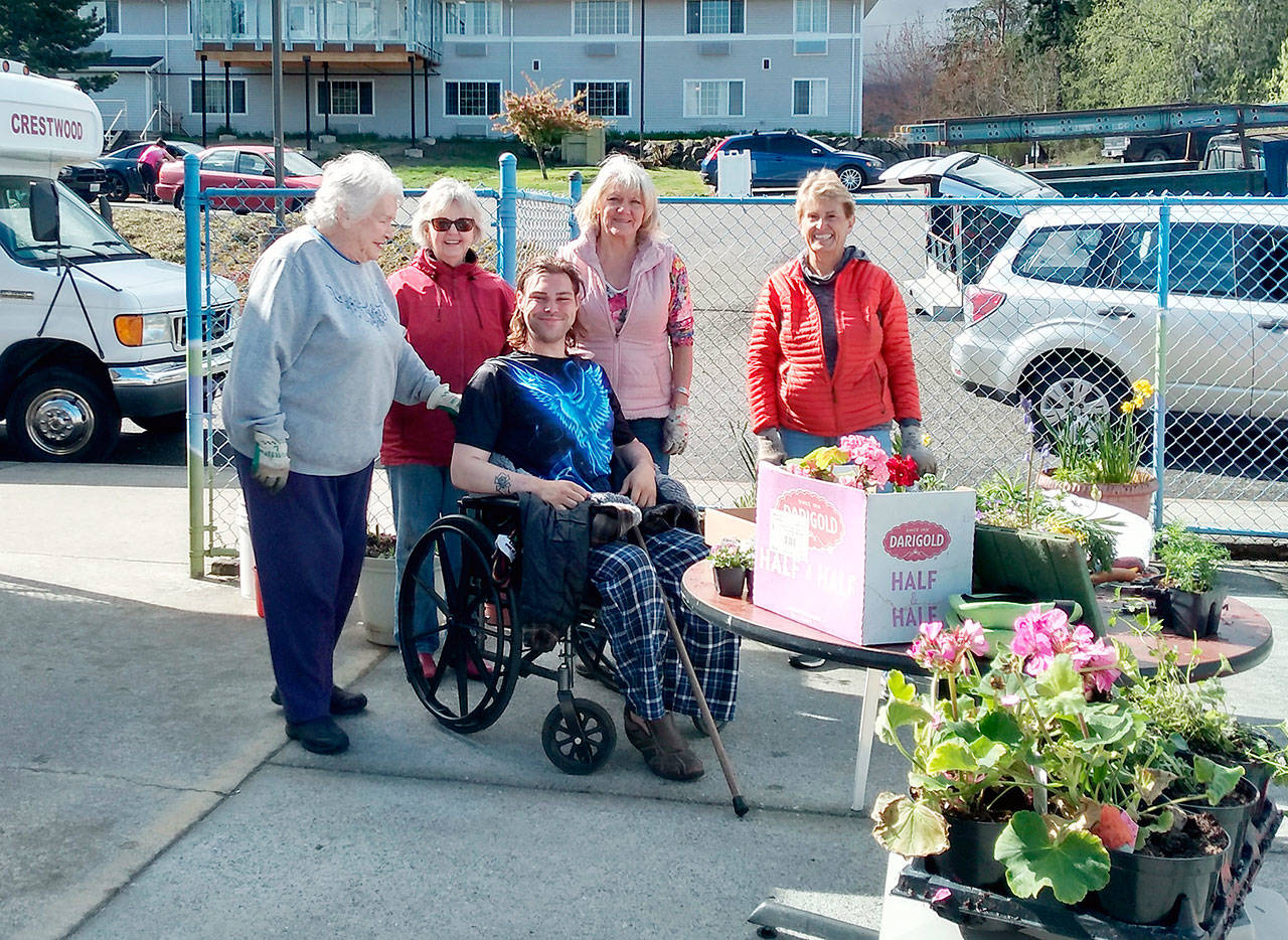 Members of the Port Angeles Garden Club recently gathered for a planting party at Crestwood Health and Rehabilitation. Club members added spring blooms to planters on the residents’ patio. Pictured standing, from left to right, are Bernice Cook, Kitty Gross, Shari Bley and Mary Kelsoe. Seated is Crestwood resident Troy Nicholaysen, who will will care for the plantings.
