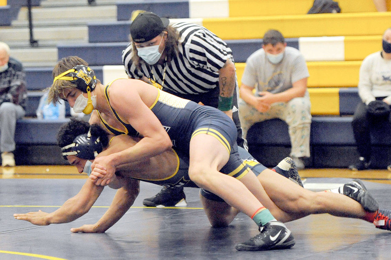 Forks’ Jake Weakley, top, pinned Ilwaco’s Keegan Kemmer in the 152-pound class Wednesday evening in Forks. Forks’ Mike Blair officiated the match. (Lonnie Archibald/for Peninsula Daily News)