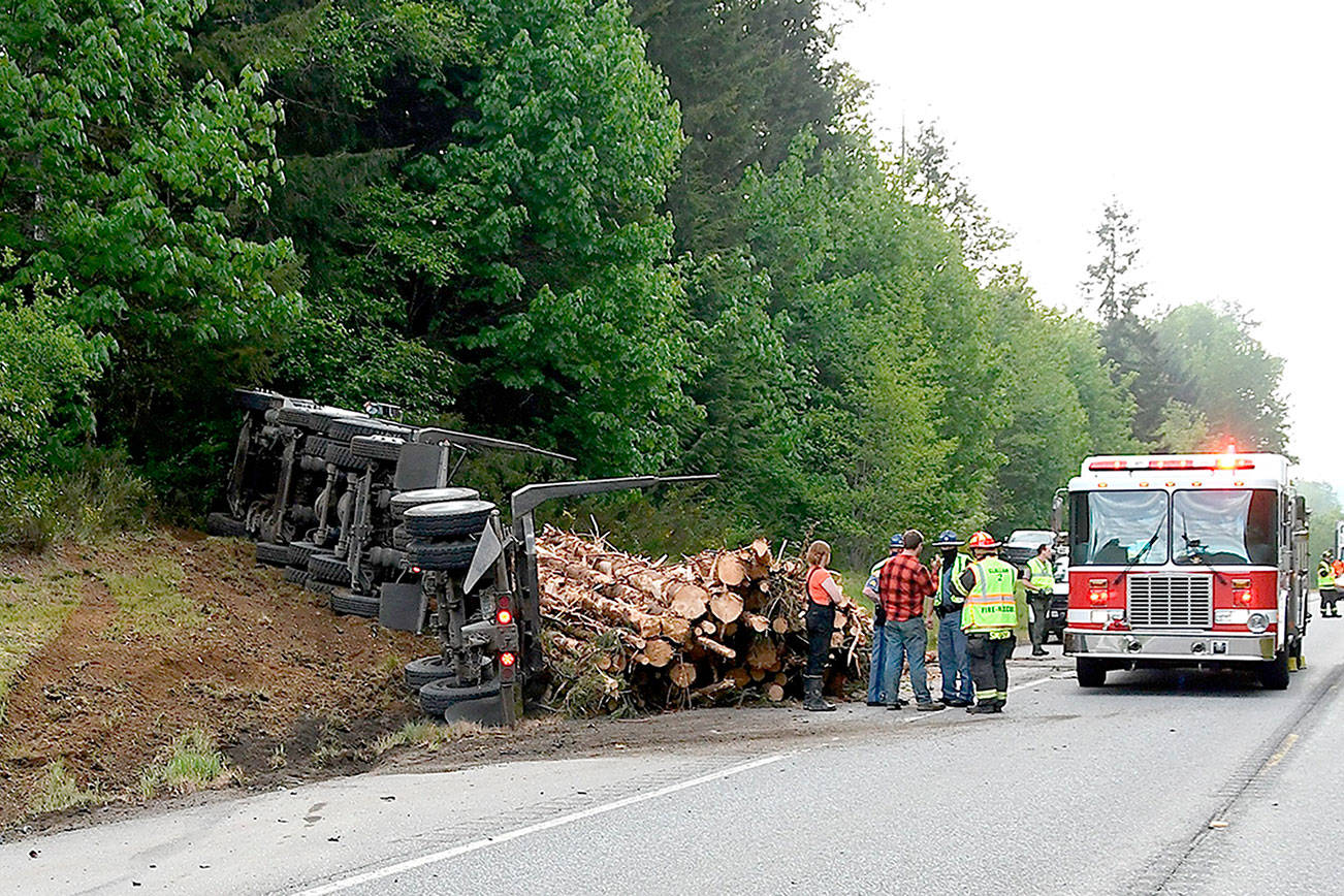 No one was injured when a log truck spilled its load after attempting to miss a car that turned in front of it. (Clallam County Fire District 2)