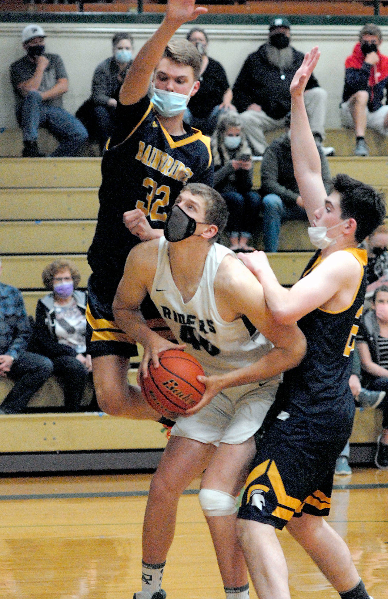 Keith Thorpe/Peninsula Daily News Port Angeles’ John Vaara, center, is surrounded by Bainbridge defenders Luike Lavigne, left, and James Carey during the third quarter on Thursday in Port Angeles.